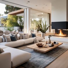 a living room filled with furniture and a fire place in the middle of it's wall