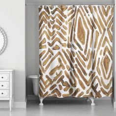 a bathroom with a shower curtain, mirror and white dresser in front of the tub