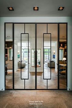 an open glass door leading into a living room