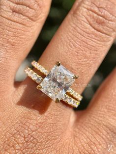 a woman's hand with a diamond ring on it