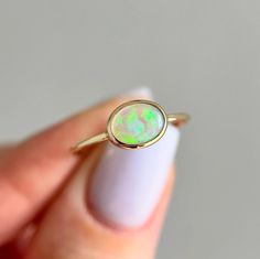 14K Yellow gold ring with Australian Crystal Opal Size: 7.25 Opal size: 8x6mm (0.5 ct) Metal: 14K yellow gold Band: 1mm Stones: Australian opal (natural untreated stone)   We offer complimentary sizing for most of our 14K gold rings, so please email us to inquire before placing an order. Gold Stone Ring, Crystal Opal, Gold Stone, 14k Gold Ring, Australian Opal, Yellow Gold Ring, Opal Crystal, Gold Band, Stone Ring