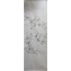 a white wall hanging with flowers on it