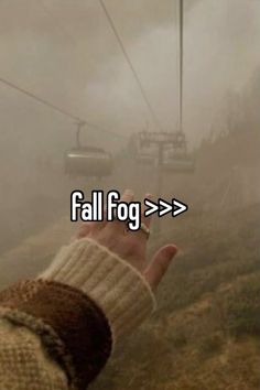 someone holding their hand up in the air with a ski lift behind them and text that reads, fall fog