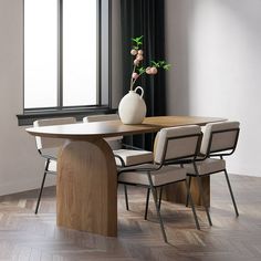 a vase with flowers on top of a wooden table next to two chairs in front of a window