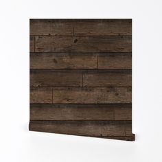 a wooden plank wall mounted to the side of a white wall