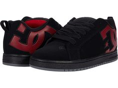 DC Court Graffik - Men's Skate Shoes : Black/Red Print : A modern classic, stay true to form with the bold logo detail and reliable comfort of the DC Court Graffik skate shoes. Skateboard shoes with soft and resilient action leather uppers for abrasion resistance and durability. Foam-padded tongue and collar for added comfort and support. Soft tricot lining. Internal elastic tongue holders for added foot stability. Highly abrasion-resistant sticky rubber cup sole. Multi-tone bottom with DC's tra Slip-on Skate Shoes With Textured Sole For Streetwear, Skate Shoes With Cushioned Footbed For Streetwear, Skateboarding Shoes With Textured Sole And Round Toe, Skate Shoes With Contrast Sole, Black Synthetic Skate Shoes With Textured Sole, Black Skateboarding Sneakers With Textured Sole, Black Sneakers With Textured Sole For Skateboarding, Black Casual Skate Shoes With Padded Tongue, Black Textured Sole Sneakers For Skateboarding