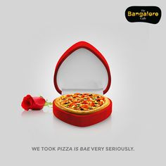 a red box with a pizza inside and a single rose on the side that says, we took pizza is every seriously