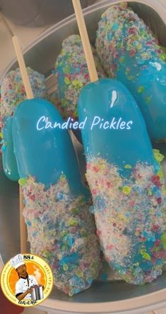 blue and white candied pickles in a plastic container