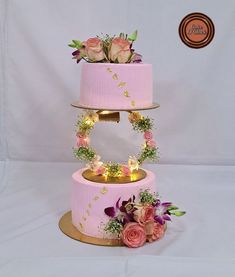 three tiered cake decorated with flowers and lights