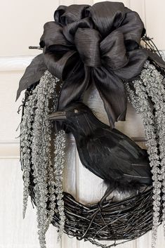 a black bird sitting on top of a wreath