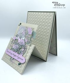 an open card with some flowers on it