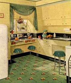 an old fashioned kitchen with green flooring and white appliances, including a refrigerator freezer