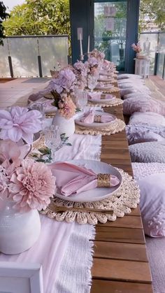 a long table with plates and flowers on it