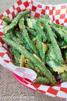 green beans with parmesan cheese on top in a red and white checkered basket