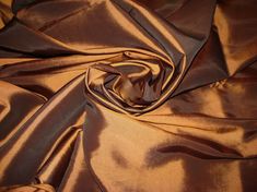 a close up view of a shiny brown fabric