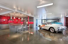 a car is parked in a garage with red tiles on the walls and flooring