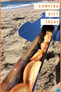 an open camping gift box with donuts in it on the sand at the beach