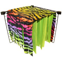 a multicolored tie - dyed table cloth is hanging from a wire rack on an isolated white background