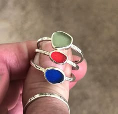 "These handcrafted Sterling Silver Stack Rings are sold individually. Color options are Sea Foam, Red or Cobalt. They have been handmade using 925 Sterling Silver that has been stamped and lightly oxidized. The glass is approximately 1/4\" wide and the bands are 1/16\" wide and cannot be resized. Size 10 Add a pop of vibrant color to your jewelry collection with these stunning Sea Glass Sterling Silver Stack Rings. Handcrafted with love and attention to detail, these unique pieces feature a capt Unique Adjustable Oval Stackable Rings, Unique Handmade Stackable Rings As Gift, Unique Handmade Stackable Rings For Gift, Unique Handmade Adjustable Stackable Rings, Unique Handmade Green Stackable Rings, Silver Stone Rings, Stack Rings, Glass Bangles, Beachglass Jewelry