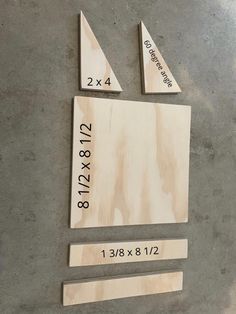 three pieces of wood sitting on top of a cement floor next to numbers and measurements