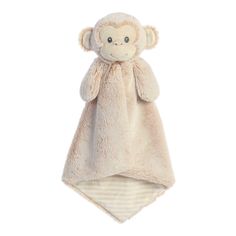 a stuffed monkey is wrapped in a blanket