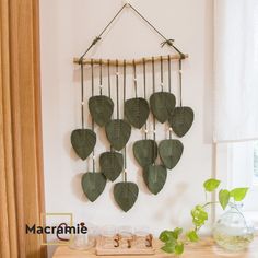 a wooden table topped with lots of green hearts hanging from the side of a wall