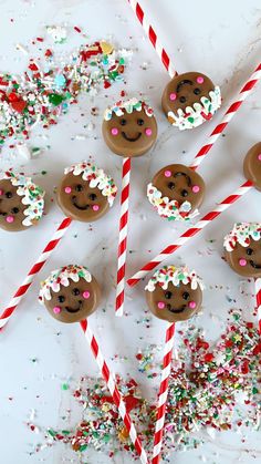 chocolate covered donuts with sprinkles and candy canes on a table