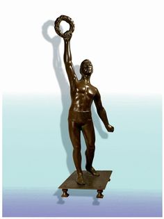 a bronze statue with a ring on it's arm and hands up in the air