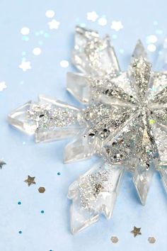 a crystal snowflake on a blue and white background with confetti sprinkles