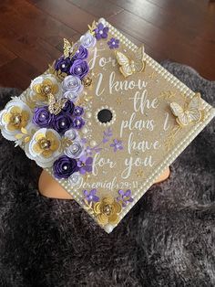 a graduation cap with flowers on it sitting on top of a furnishing area