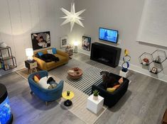 a living room filled with furniture and a flat screen tv mounted to the side of a wall