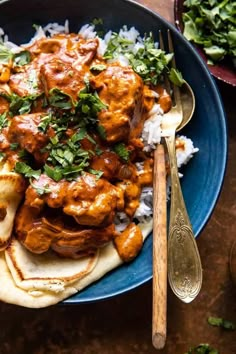 a blue plate topped with chicken and rice