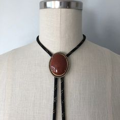 A lovely vintage bolo in perfect condition! Great gift for someone this holiday season! Introduction to Goldstone: Here's some good advice 🪶 Keep calm and carry the Goldstone crystal to ensure a golden future. Because let's be realistic--the mysterious abyss of the unknown--also known as the future--can be a daunting aspect. Known as the 'ambition' stone, the Goldstone crystal meaning is linked with boosting your drive and confidence, the essential mindset for paving the way for all your dreams 70s Jewelry Necklaces, Western Jewelry With Adjustable Chain, Western Lariat Jewelry As Gift, Western Style Jewelry With Adjustable Chain, Western Style Lariat Jewelry As Gift, Western Style Lariat Jewelry For Gifts, Western Style Gold Lariat Jewelry, Western Lariat Jewelry For Festival, Western Style Lariat Jewelry With Adjustable Length