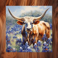 a painting of a longhorn bull in a field of bluebondelions on a wooden background