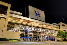 a large building with the words common water stadium lit up at night