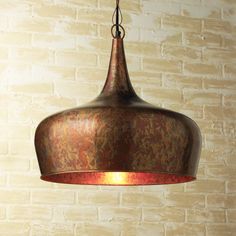 a light fixture hanging from a brick wall