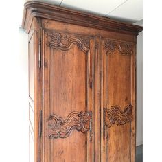 an old wooden armoire with carvings on it