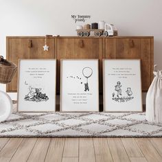 three framed pictures sitting on top of a wooden floor next to a basket and wall