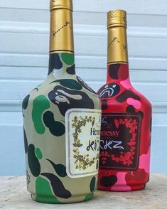 two bottles of hennesy pink and green liquor