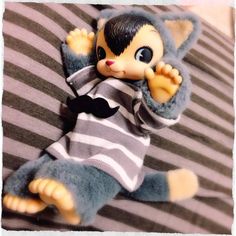 a small stuffed animal wearing a striped shirt