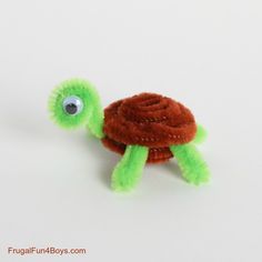 a small stuffed turtle with an eye on it's back