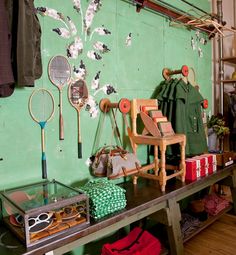 a room with green walls and lots of items on the table in front of it