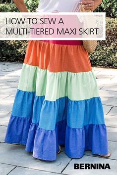 a woman wearing a multi - tiered skirt with text overlay reading how to sew a multi - tiered midi skirt