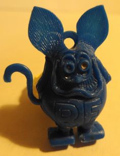 a blue figurine that looks like a cartoon character with big ears and eyes