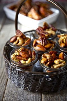 a basket filled with nuts sitting on top of a wooden table