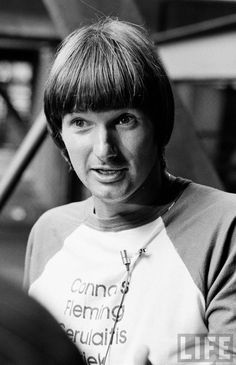 a black and white photo of a woman wearing a t - shirt