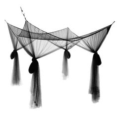 black and white photograph of three nets hanging from the ceiling with tassels