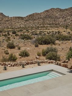 an empty pool in the middle of a desert