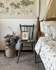 a bedroom with a bed, chair and pictures on the wall