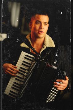 a man holding an accordion in his hands